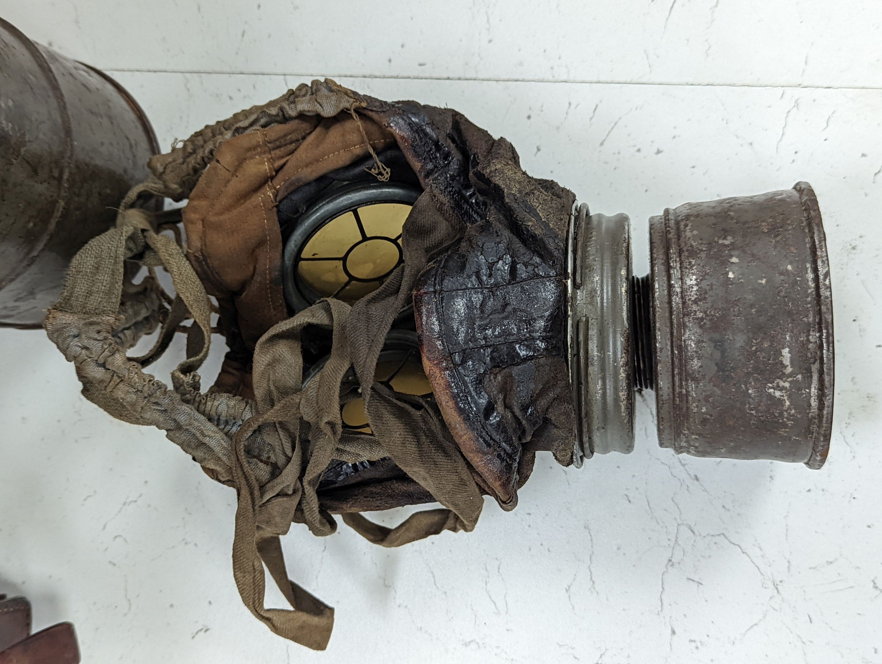 WWI German gas mask, two German trench mess tins and a German leather belt case